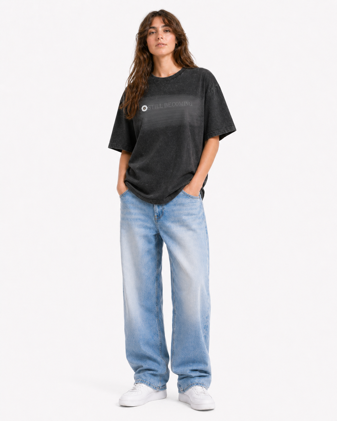 Black acid-wash t-shirt with STILL BECOMING graphic, model front view on white background